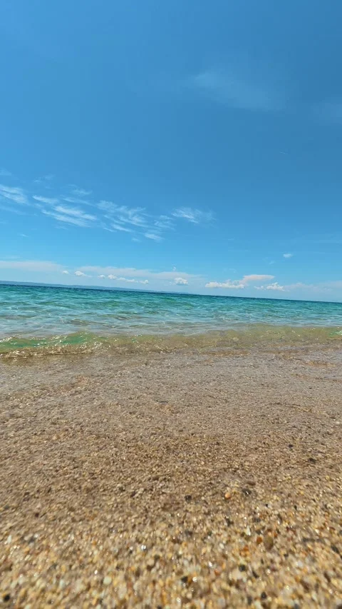 Clear blue sky meets calm turquoise sea. Lagomandra, Greece. Vertical Stock Footage 339627724