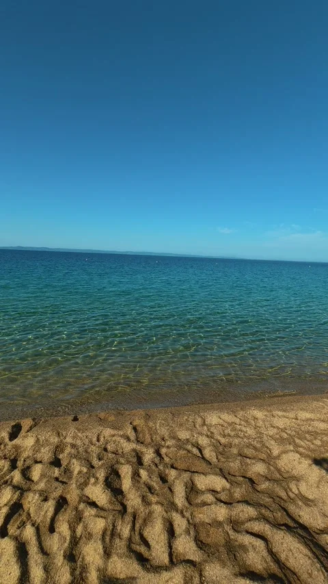 Clear blue sky meets gentle waves. Lagomandra, Greece. Vertical Video stock 339624443