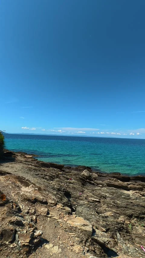 Clear blue sky meets turquoise sea. Lagomandra, Greece. Vertical Stock Footage 339626791