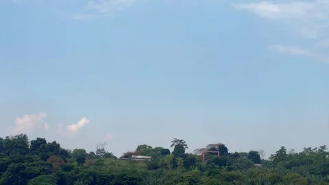 Clear blue sky over tropical green hills and trees Vidéo 340485627