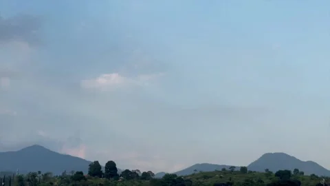 Clear blue sky over tropical mountains panning sideways 스톡 동영상 341889025