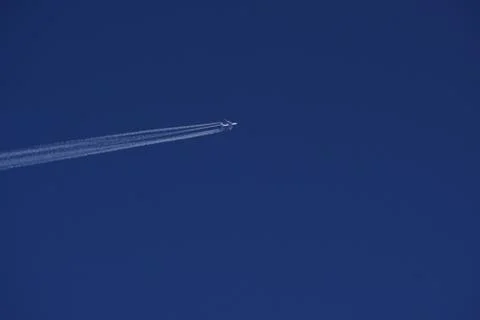 Clear blue sky with random traces of burned fuel from the plane on a clear Su Stock Photos