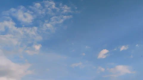 Clear blue sky with scattered white clouds on a sunny day. Stock Footage 320504882