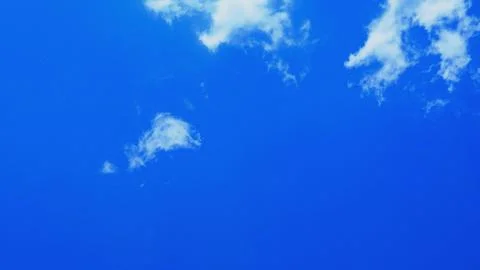 Clear Blue Sky with Small White Clouds and Copy Space Stock Photos