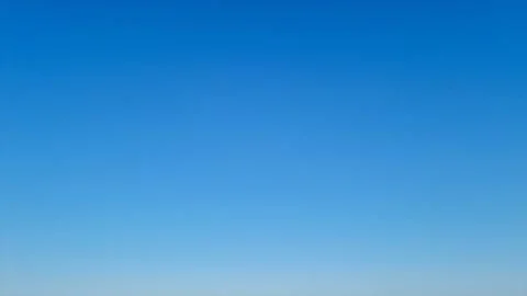 Clear blue sky with smooth gradient on a sunny day Stock Photos