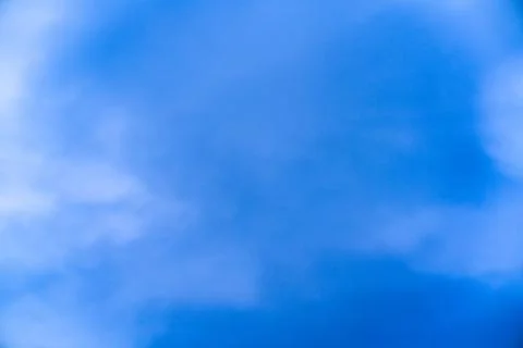 Clear blue sky with soft clouds during a sunny day Stock Photos