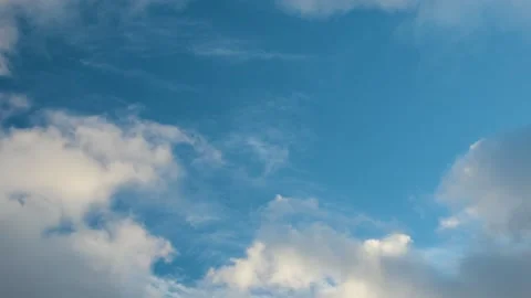 Clear blue sky with soft white clouds. Puffy white clouds drift slowly across Stock Footage 337631917