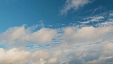Clear blue sky with soft white clouds. Puffy white clouds drift slowly across Stock Footage 337632698