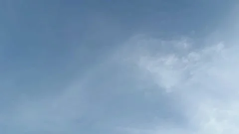 Clear blue sky with soft white clouds moving slowly background video Stock Footage 339930986