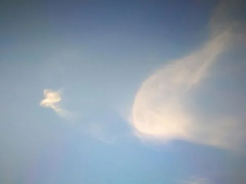 Clear blue sky with soft white clouds look like phoenix bird Stock Photos