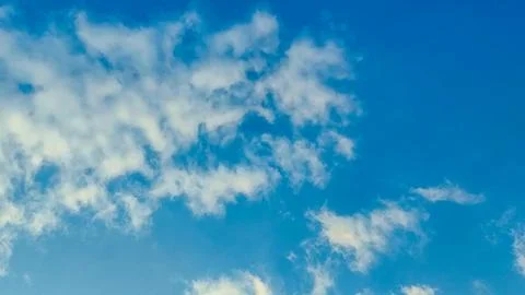 Clear blue sky with soft, wispy clouds. Stock Photos