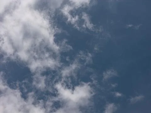 Clear blue sky with sparse white clouds 写真素材