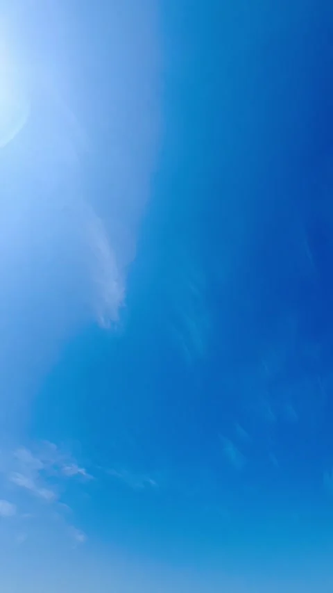 Clear Blue Sky with Subtle White Cirrus Clouds and Bright Sunlight Flare Stock Footage 341803715