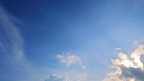 Clear Blue Sky with Sunlit Clouds. Nature Background Photos