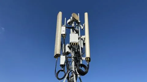 Clear blue sky with tall cellular tower structure Stock Photos