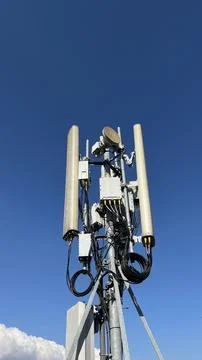 Clear blue sky with tall cellular tower structure Stock Photos