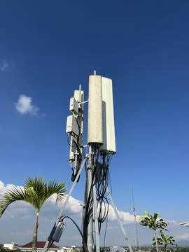 Clear blue sky with tall cellular tower structure Stock Photos