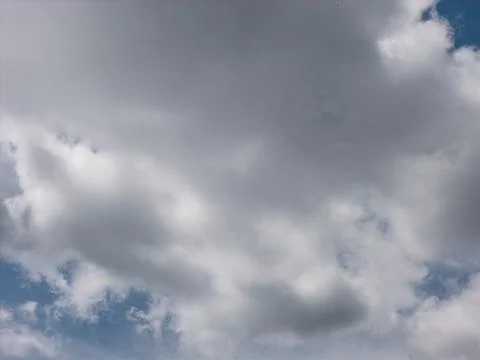 Clear blue sky with white clouds on a sunny day Stock Photos