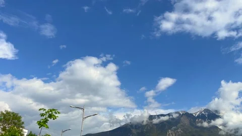 Clear blue sky with white fluffy clouds and sunlight Stock Footage 310269953