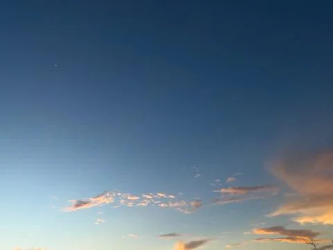 Clear Blue Sky With Wispy Sunset Clouds Stock Photos