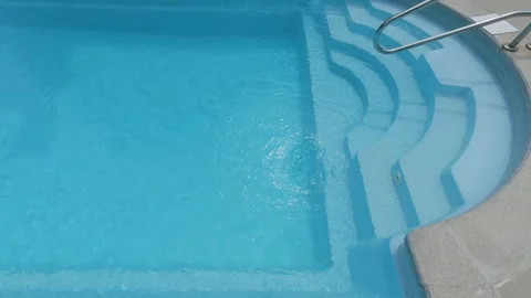 Clear Blue Swimming Pool Entry Steps with Metal Handrail at Resort Stock-Footage 344270242