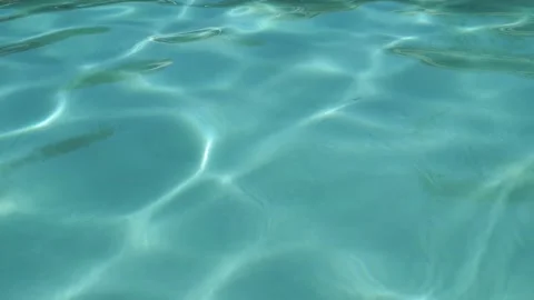 Clear Blue Swimming Pool Water Rippling Softly Under Bright Sunlight Stock Footage 339086799