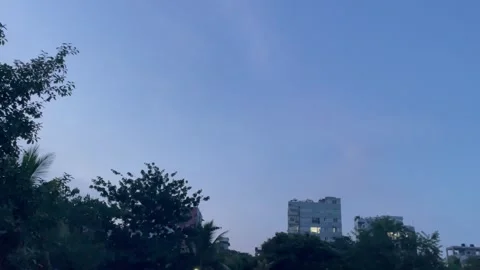 Clear Blue Twilight Sky with City Building Silhouette and Trees Stock-Footage 345980175