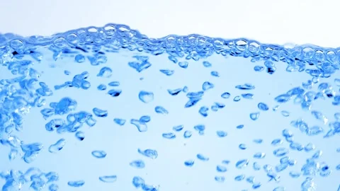 Clear blue water boiling with rising oxygen bubbles and dynamic liquid move.. Stock Footage 337337401