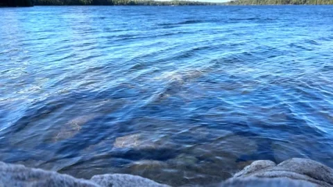 Clear blue water of Long Pond in Acadia National Park with rocks view Stock Footage 329003956