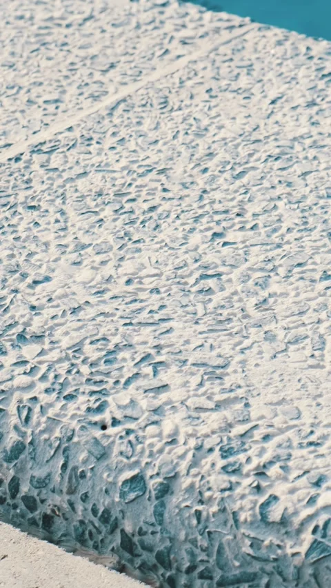 Clear blue water in the pool. The edge of the pool is finished with gray curbsto Stock Footage 310264728