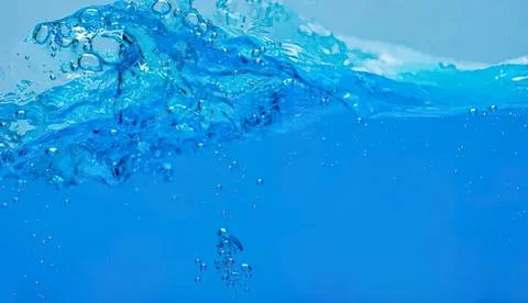 Clear blue water splash with bubbles in a swimming pool Stock-Fotos