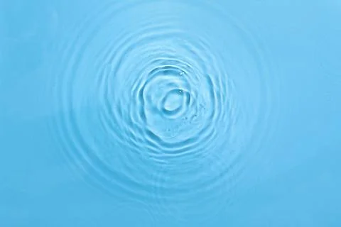 Clear blue water surface with concentric ripples and gentle waves, refreshing Stock Photos