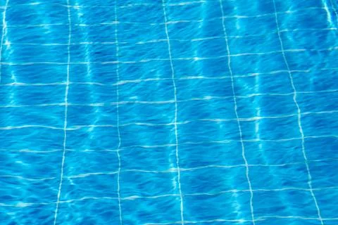 Clear Blue Water Surface With Grid Pattern Reflecting Sunlight on a Sunny Day Stock Photos