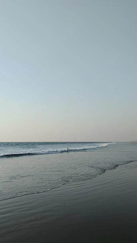 ?Clear Blue Water Waves Approaching Sandy Coastline Under Bright Sky Stock Footage 329917375