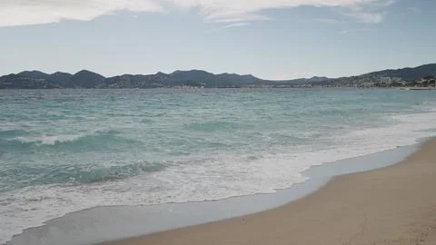 Clear blue waves with strong wind on a sandy empty beach in Cannes with Theoule Stock Photos