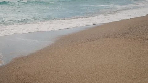Clear blue waves with strong wind on a sandy empty beach in Cannes in spring Stock Photos