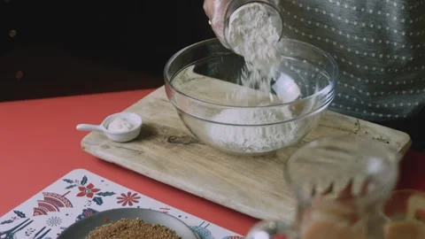 Clear bowl receiving a fresh cascade of flour Stock Footage 342128416
