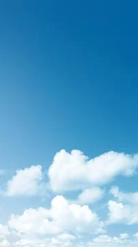 Clear bright blue sky background with fluffy white cumulus clouds at the bo.. Stock Photos