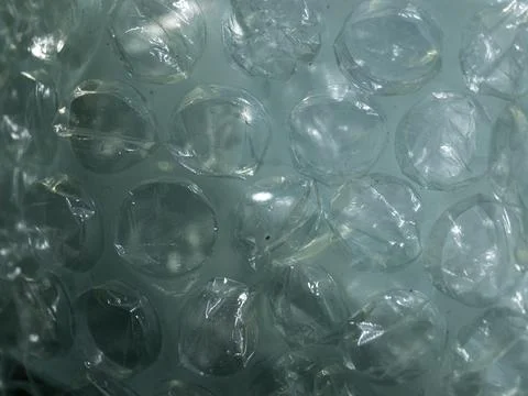 Clear, bubble-textured plastic material glows softly Stock Photos