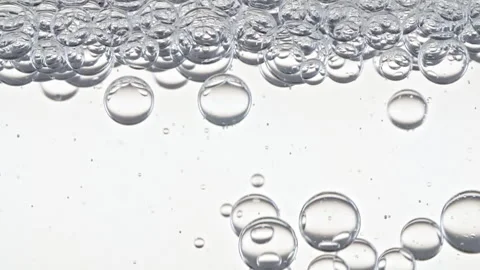 Clear Bubbles Form and Float to Another Ones on Transparent Surface on White Stock Footage 266940808