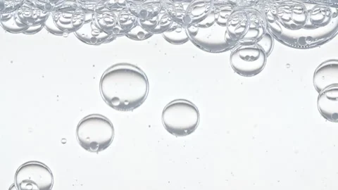 Clear Bubbles Form and Float to Another Ones on Transparent Surface on White Vídeo Stock 272590173