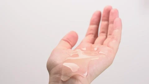Clear cleansing shampoo or shower gel flowing from palm of hand. Haircare, .. Stock Footage 277594846