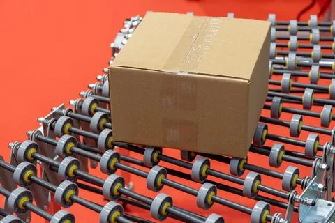 A clear, close-up view captures a simple, sealed brown cardboard box resting  Stock Photos