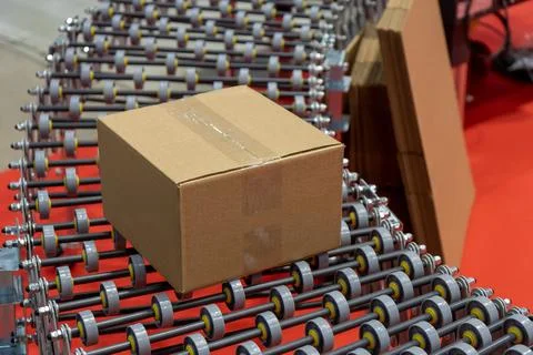 A clear, close-up view captures a simple, sealed brown cardboard box resting  Stock Photos