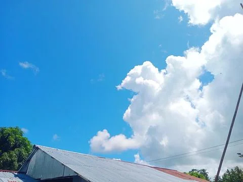 Clear cloudy sky during the day in the village Stock Photos