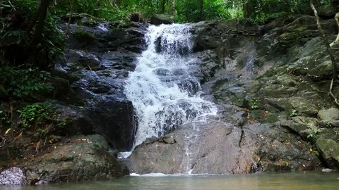Clear cold waterfall flow into rock Stock Footage 95654894