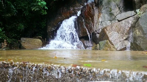 Clear cold waterfall flow into rock , blur defocus ground floor with water fl Stock Footage 95660699