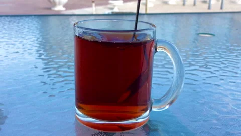 In a clear cup with a teaspoon of sugar is mixed Stock Footage 140449325