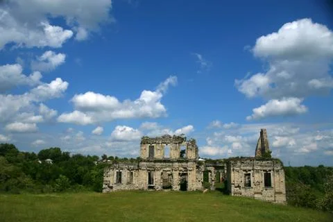 Clear day White clouds An abandoned building made of stone stands in the middle Stock Photos