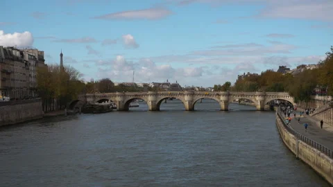 Clear daytime view of the Pont Neuf bridge spanning the Seine River in Paris Stock Footage 320452137